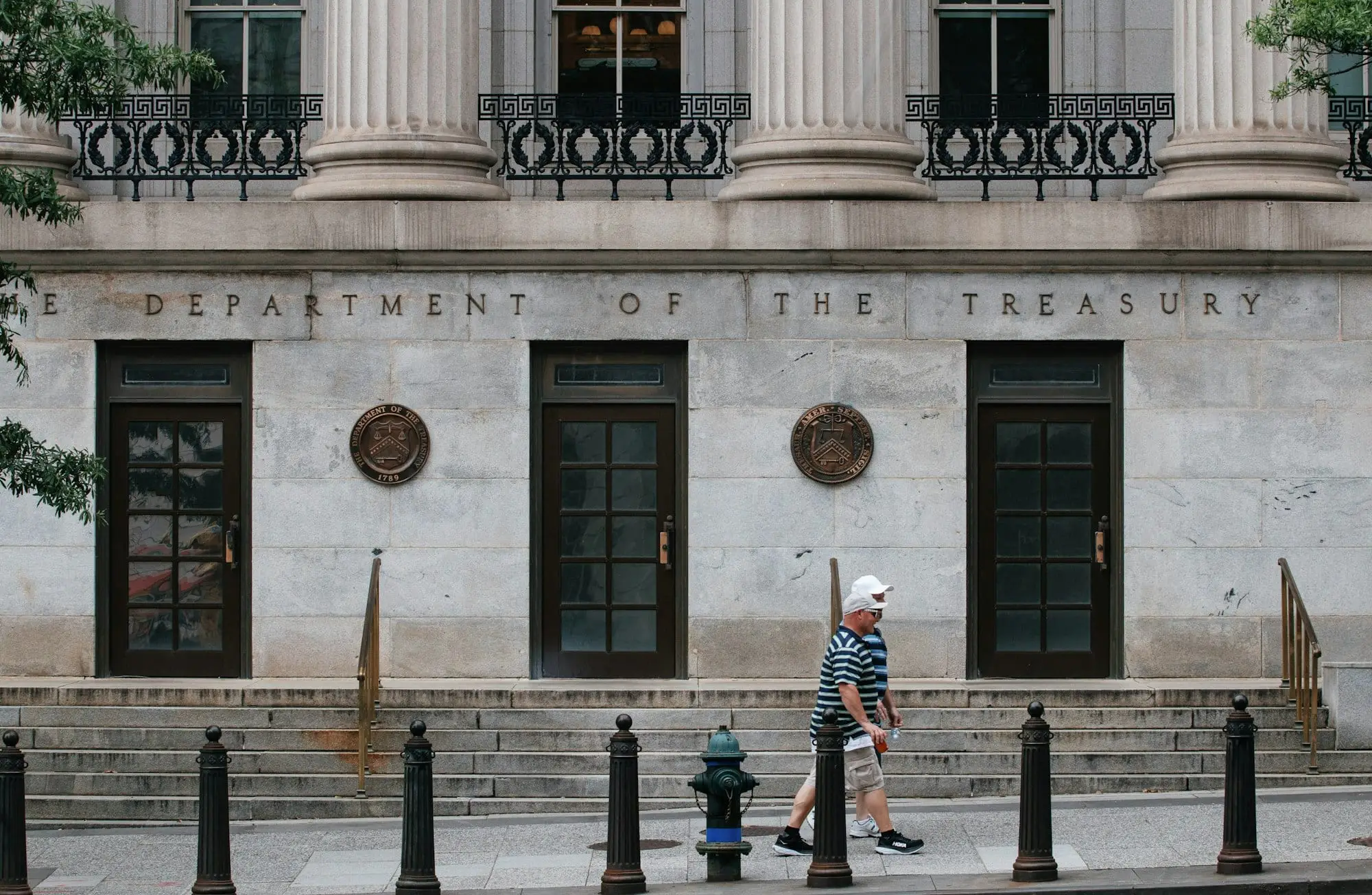 Entrance of the US Department of the Treasury building in Washington, with its name carved above the doors